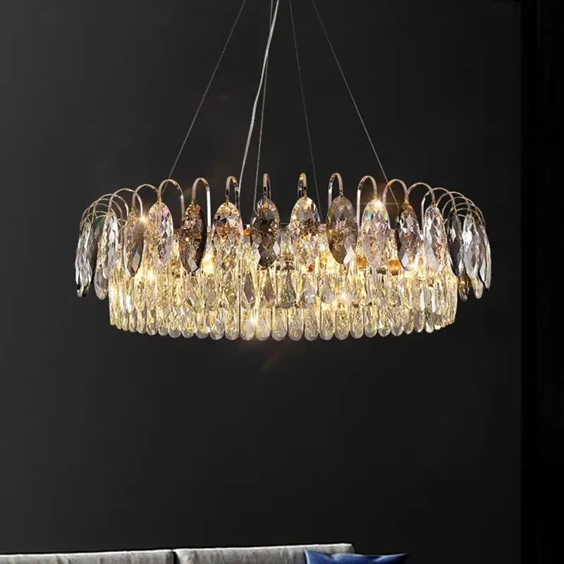 A modern decorbites crystal chandelier pendant light with polished gold frame and cascading crystal teardrops for elegant rooms