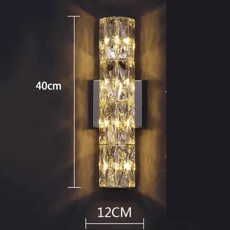 DecorBites crystal chandelier wall-mounted light with faceted crystal segments emitting warm golden illumination