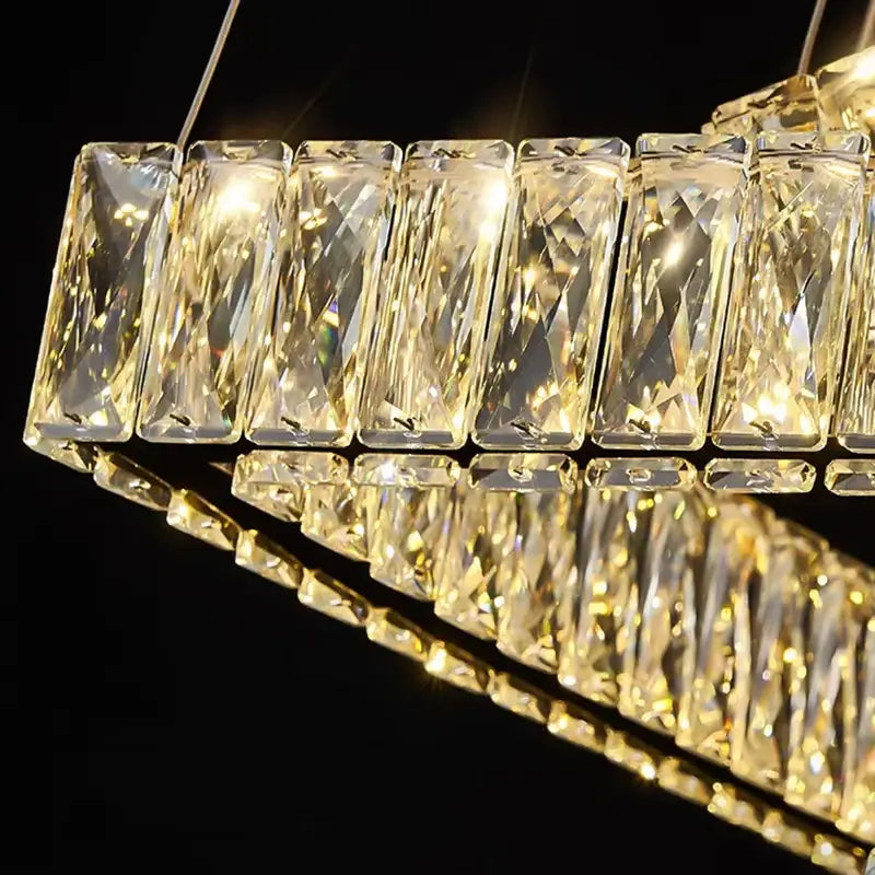 A modern decorbites crystal chandelier with faceted transparent glass in a sleek rectangular design for elegant living rooms