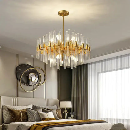 Gold-toned decorbites crystal chandelier with clear glass rods and cylindrical accents for elegant pendant lighting