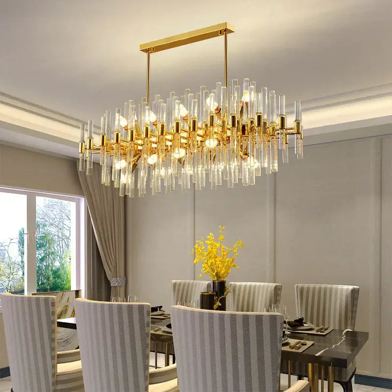 Gold-toned decorbites crystal chandelier with clear glass tubes and exposed bulbs for elegant home and hotel lighting