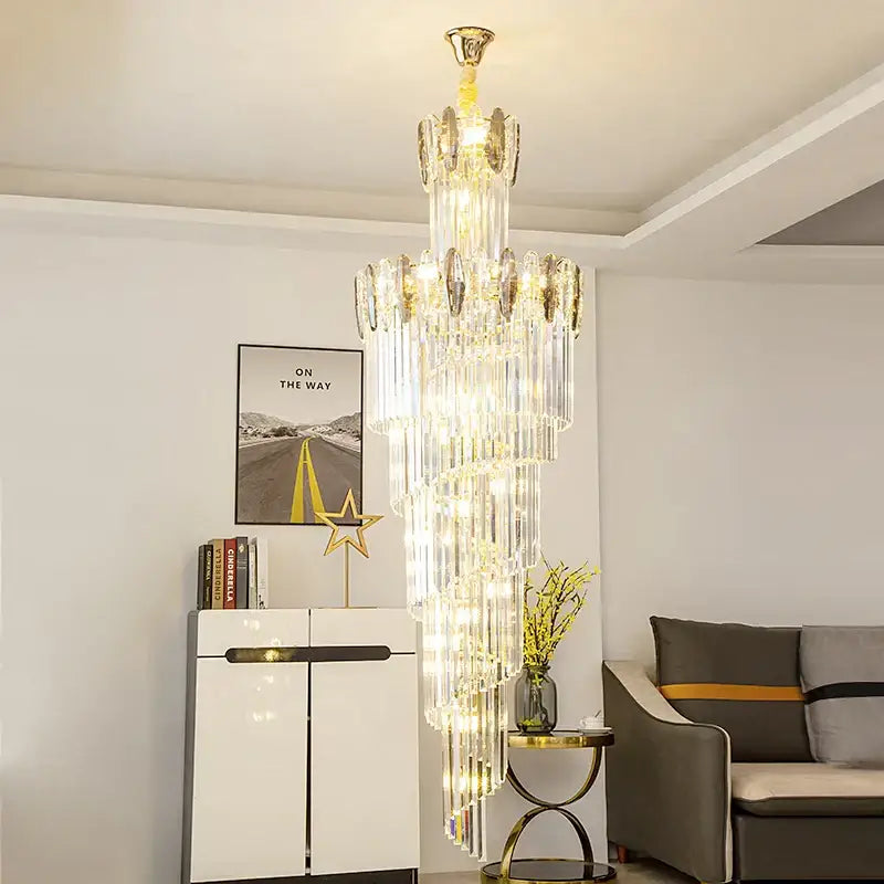 A decorbites crystal chandelier with gold-toned metal and clear crystal prisms for minimalist duplex living room lighting