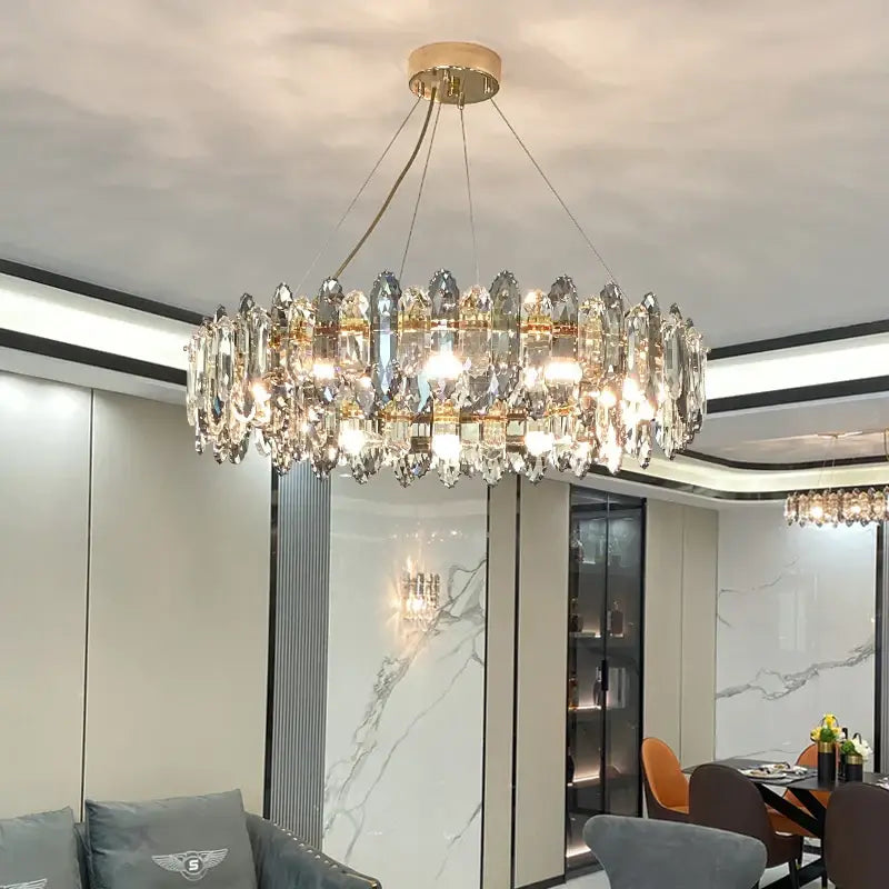 A modern decorbites crystal chandelier with clear crystal droplets and gold-toned metal accents for elegant spaces