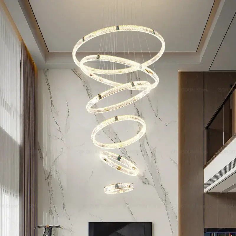 A modern decorbites crystal chandelier featuring glowing crystal-encrusted rings with gold accents for elegant lighting
