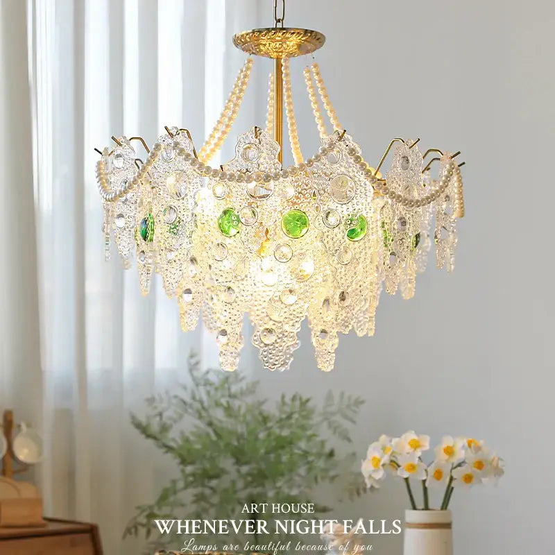 Decorbites crystal chandelier with golden finish and cascading crystal droplets accented by green glass orbs for elegant lighting