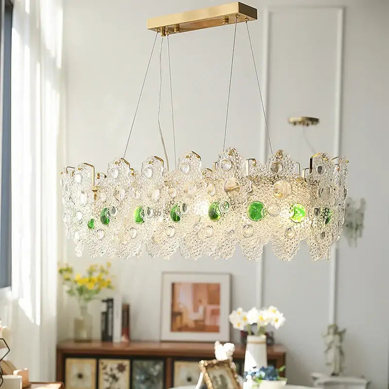 A modern decorbites crystal chandelier with gold metal frame and clear glass green beads for elegant retro lighting