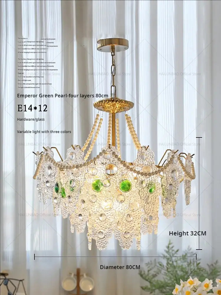 A luxurious decorbites crystal chandelier with golden frame and cascading clear and emerald green beads for elegant lighting