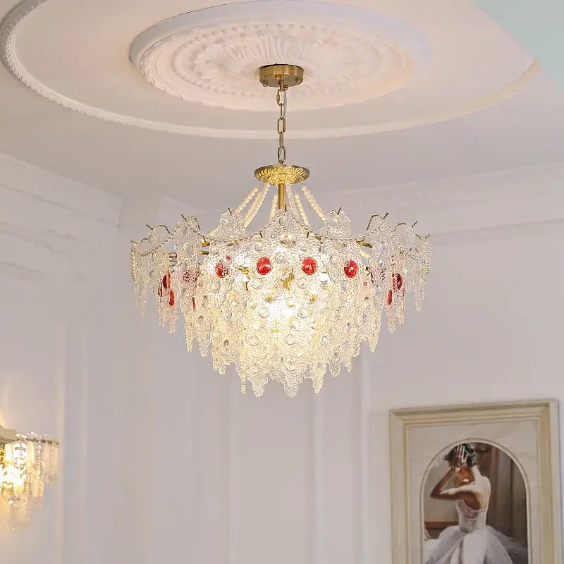 Elegant decorbites crystal chandelier with gold-toned metal and red gemstone details for bedroom and dining rooms