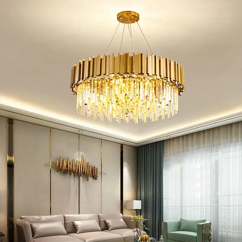 Gold-toned decorbites crystal chandelier with circular metallic frame and cascading clear prisms for elegant living space lighting