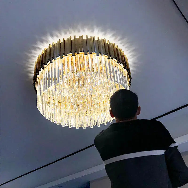 A modern decorbites crystal chandelier with gold-toned metal frame and clear crystal prisms for elegant living space lighting