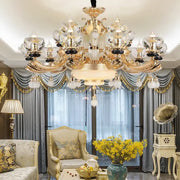 Gold-toned decorbites crystal chandelier with intricate ornate detailing and multiple tiers for living dining and bedroom