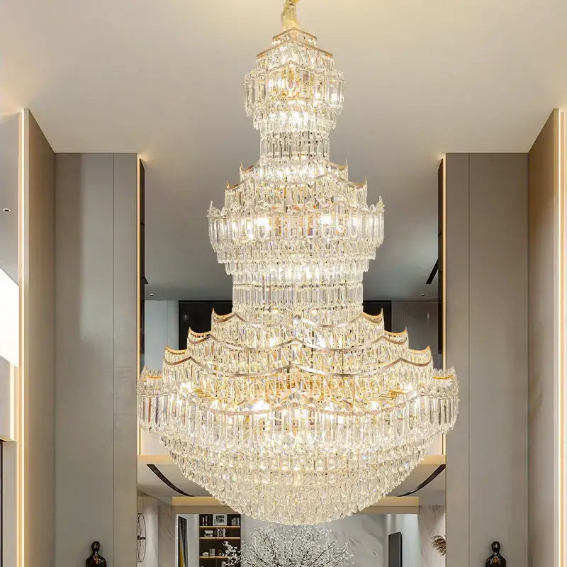A decorbites crystal chandelier with a gold-toned frame and cascading faceted crystals for villa lobby staircases