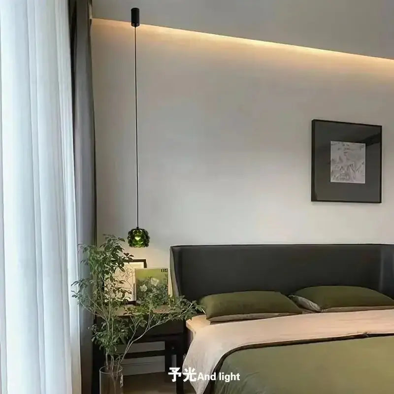 A sleek black pendant light with a green faceted glass globe from decorbites crystal chandelier for clothing store cashier area