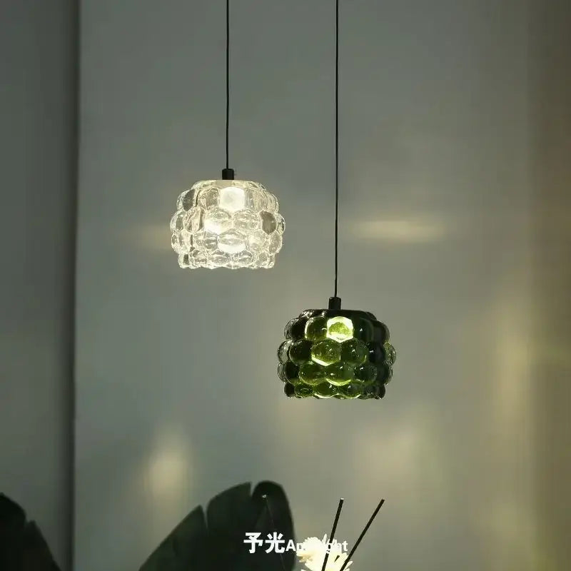 Two hanging glass pendant lights with textured bubble design in clear and green for decorbites crystal chandelier