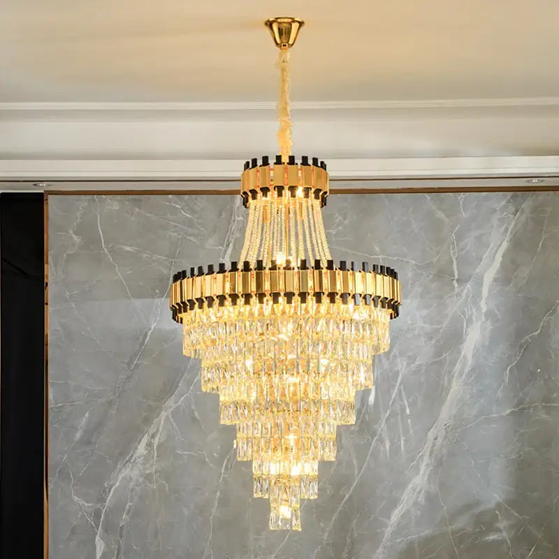 Golden tiered DecorBites crystal chandelier with cascading crystal prisms and black accents for villa hotel lighting