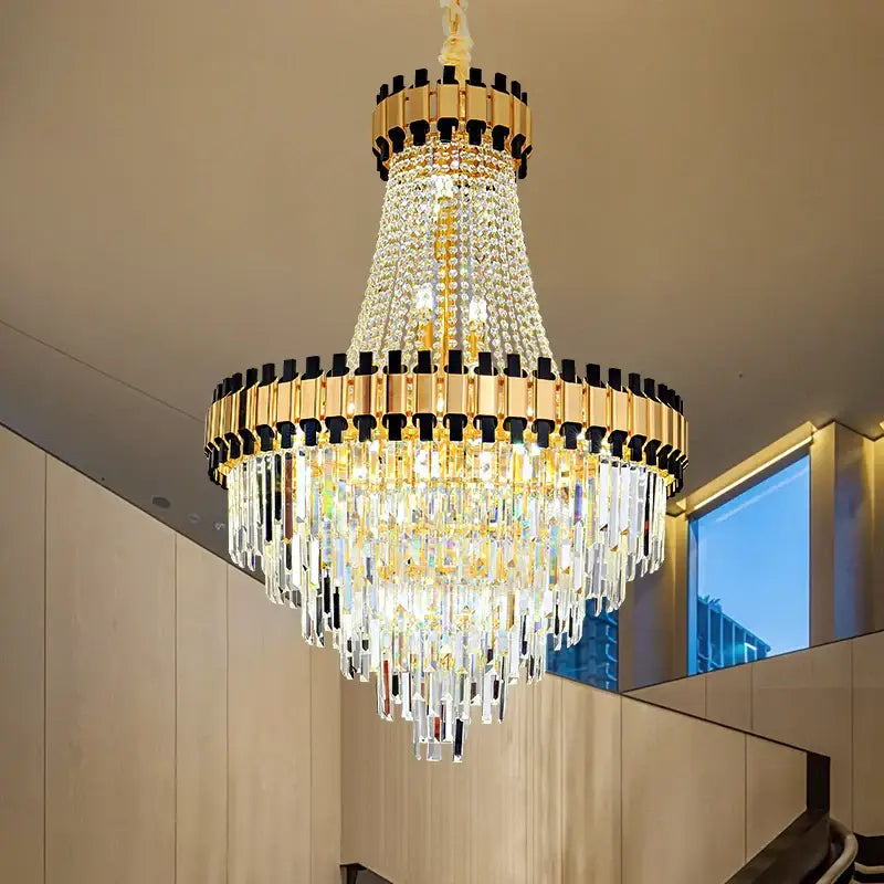Decorbites crystal chandelier in gold with castle-inspired top and cascading prisms for duplex villa living room