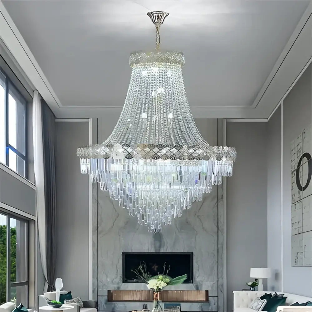 A decorbites crystal chandelier with cascading clear faceted crystals on a polished metallic frame for duplex living rooms