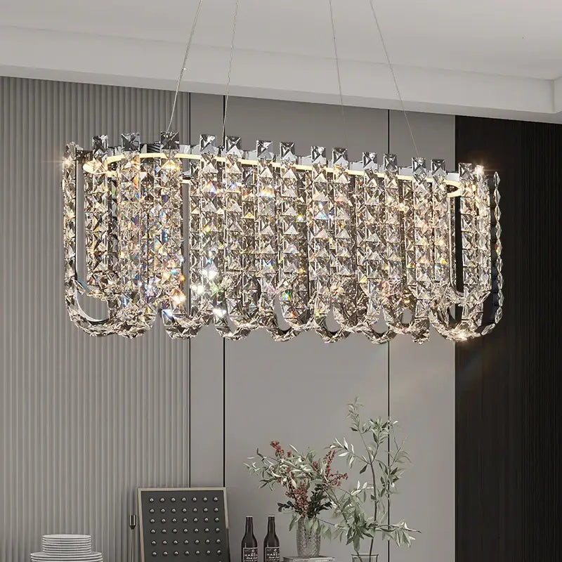 A modern decorbites crystal chandelier with cascading crystal prisms and polished chrome frame for elegant spaces