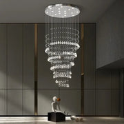 A modern chrome top decorbites crystal chandelier with cascading clear droplets for high ceilings living rooms