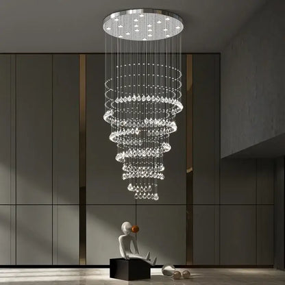 A modern chrome top decorbites crystal chandelier with cascading clear droplets for high ceilings living rooms