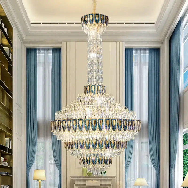 A multi-tiered decorbites crystal chandelier with gold-toned metalwork and blue accents for designer duplex rooms