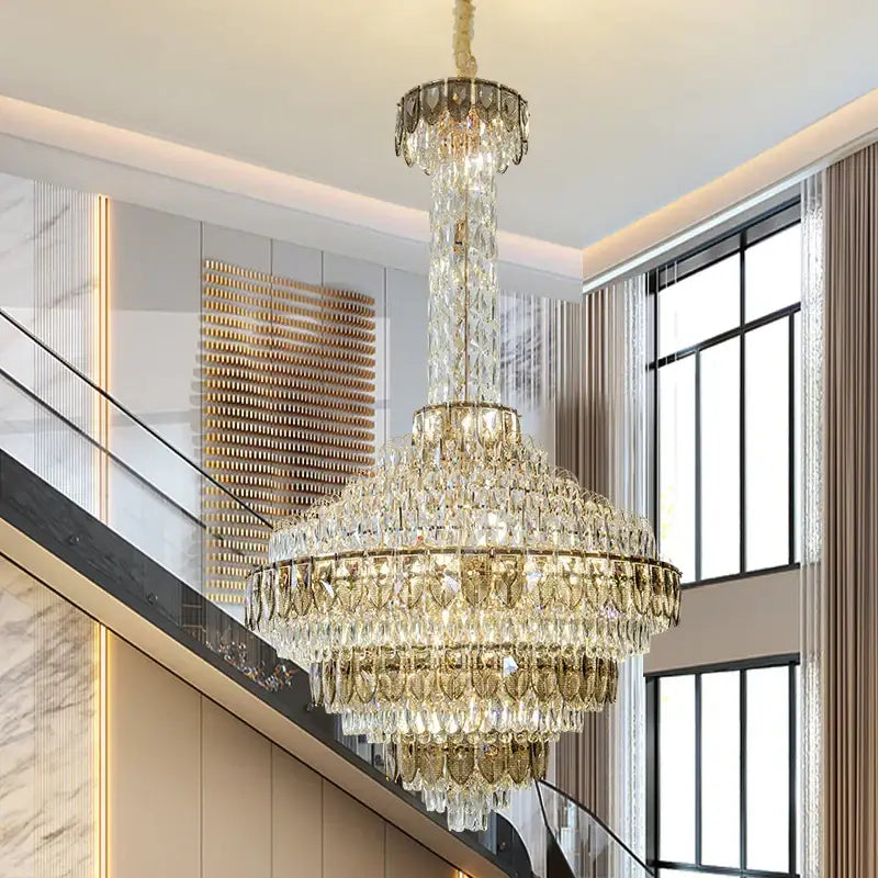 A decorbites crystal chandelier with gold-toned metal and cascading clear crystals for high-end duplex living rooms