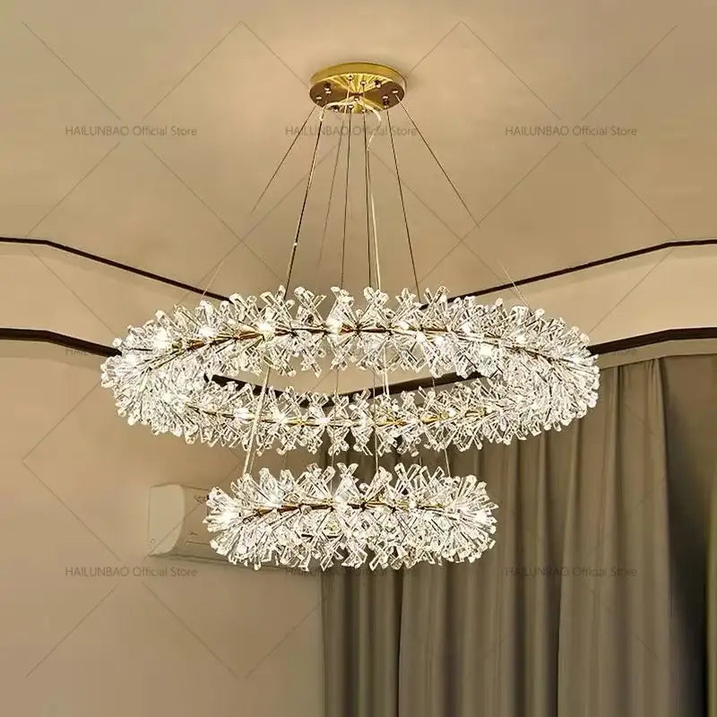 A decorbites crystal chandelier with three tiers of intricate crystal clusters and a gold-toned ceiling mount for elegant lighting