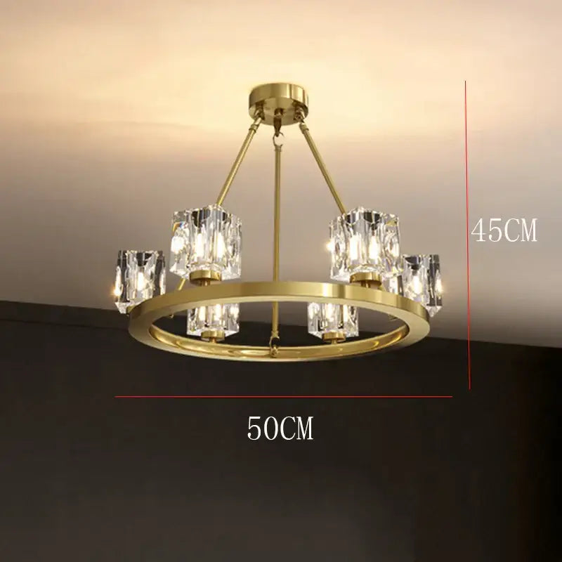 Gold-toned DecorBites crystal chandelier with circular frame and six faceted crystal shades for dining room lighting