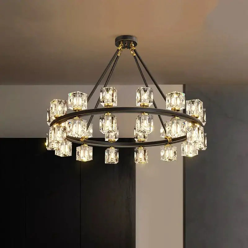 A modern two-tiered decorbites crystal chandelier with black metal frames and clear crystal cube pendants for living room lighting