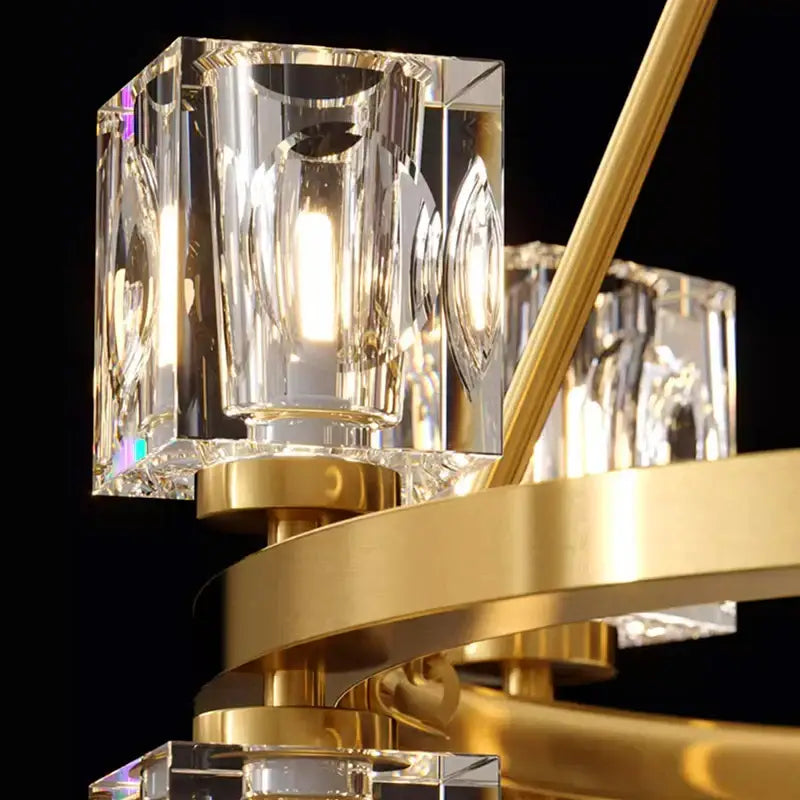 A decorbites crystal chandelier featuring faceted crystal cubes and gold-toned metal arms for dining room lighting