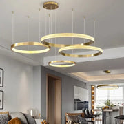 Modern gold-toned circular pendant lights with textured illuminated rings in decorbites crystal chandelier for living room