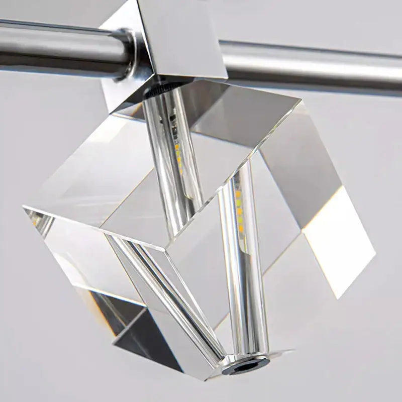 A modern decorbites crystal chandelier with faceted glass panels and chrome finish for living and dining rooms
