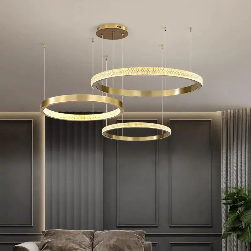 Modern gold-toned circular pendant light with intricate mesh detailing and warm led illumination by decorbites crystal chandelier