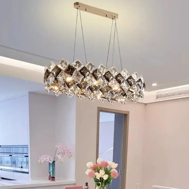 A modern oval decorbites crystal chandelier with metallic frame and faceted crystals for living and dining rooms