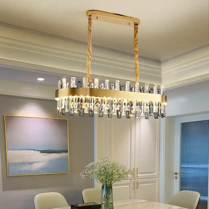 Gold-toned decorbites crystal chandelier with dangling crystal rods and twisted rope chains for living room lighting