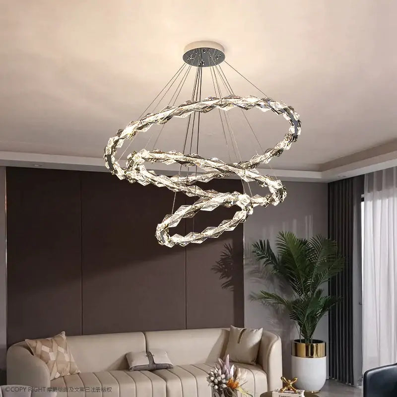 A modern decorbites crystal chandelier with interlocking crystal rings suspended from a circular ceiling mount