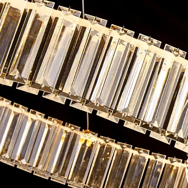 A modern two-tiered crystal chandelier with clear faceted bars and sleek metallic frame by decorbites crystal chandelier