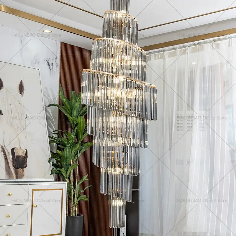 A multi-tiered decorbites crystal chandelier with clear crystal rods and gold-toned accents for penthouse living room