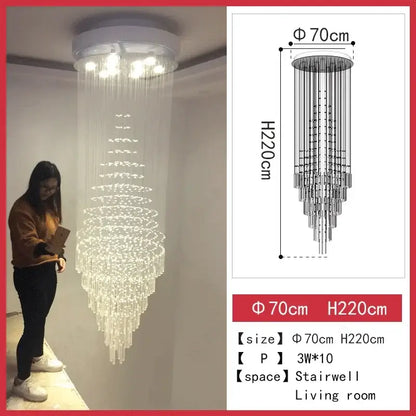 A tall cascading DecorBites crystal chandelier with white ceiling mount and multi-tier glass elements for staircase and living room