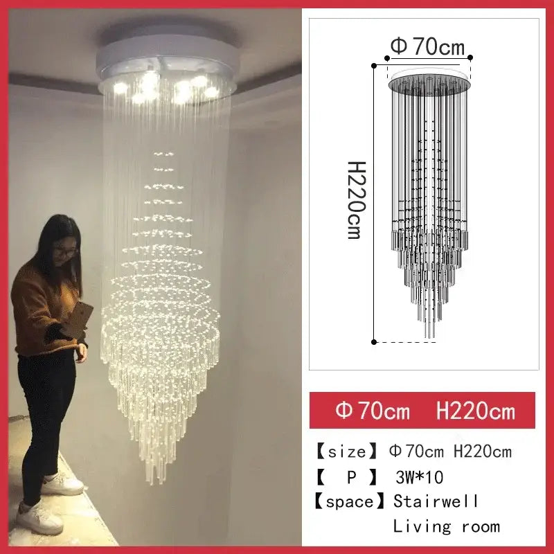A tall cascading DecorBites crystal chandelier with white ceiling mount and multi-tier glass elements for staircase and living room