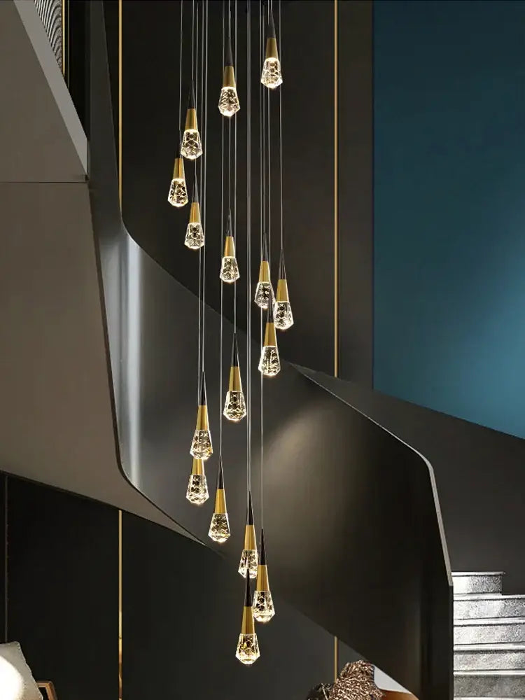 A modern decorbites crystal chandelier with gold-toned bases and teardrop pendants for stairwell and living room lighting