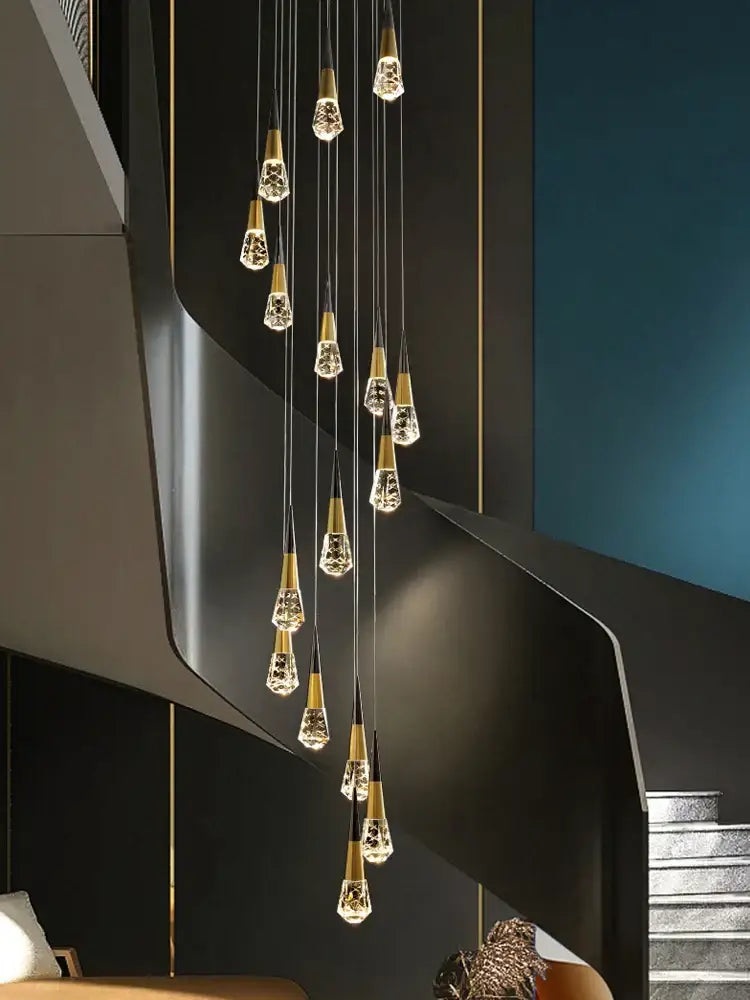 A modern decorbites crystal chandelier with gold-toned metal and crystal droplets for stairwell and living room lighting