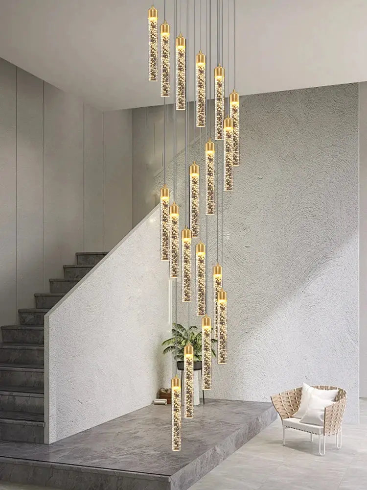 Modern gold-toned cylindrical decorbites crystal chandelier with embedded glass beads for two-storey foyer and stairwell