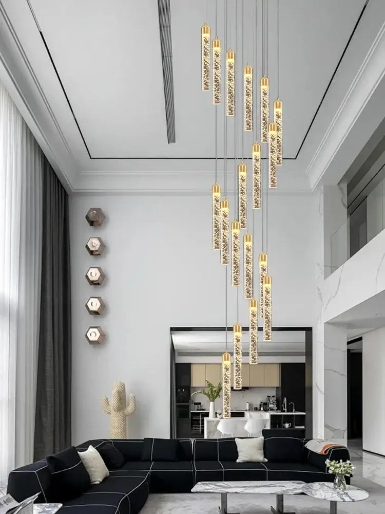 A decorbites crystal chandelier featuring vertical glass tubes with sparkling crystals and gold accents for circular stairwell