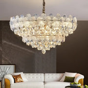A decorbites crystal chandelier featuring layered petal-shaped glass and teardrop crystals in french cream for luxury living spaces