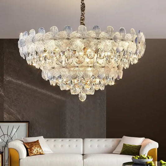 A decorbites crystal chandelier featuring layered petal-shaped glass and teardrop crystals in french cream for luxury living spaces