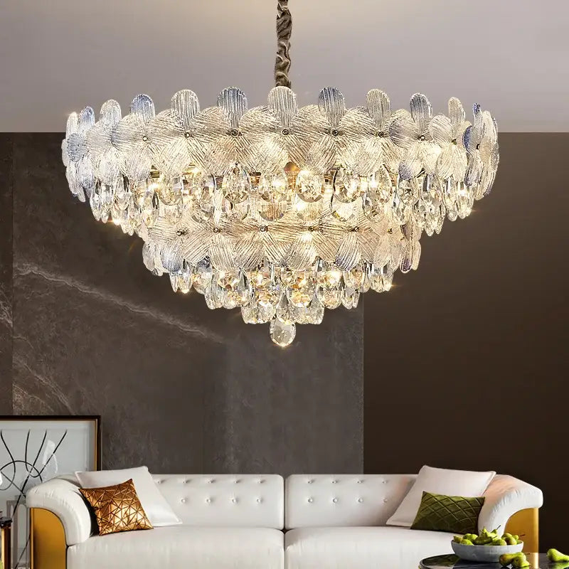A decorbites crystal chandelier featuring layered petal-shaped glass and teardrop crystals in french cream for luxury living spaces