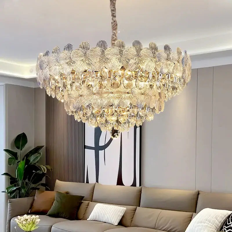 Luxurious gold-toned decorbites crystal chandelier with layered leaf-shaped glass and teardrop crystals for living room luxury