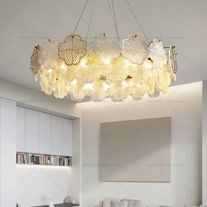 Elegant gold-toned decorbites crystal chandelier with layered translucent glass petals for living and dining rooms