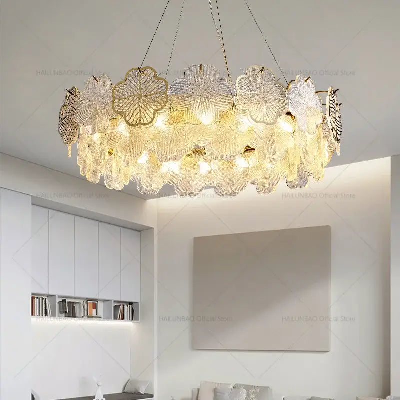 Elegant gold-toned decorbites crystal chandelier with layered translucent glass petals for living and dining rooms